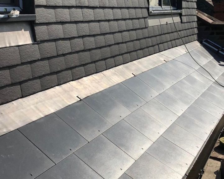 New lead flashing installed on a slate roof in Guildford.