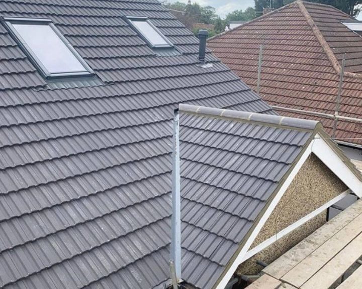 A new grey tiled pitched roof installed on a house in Guildford.